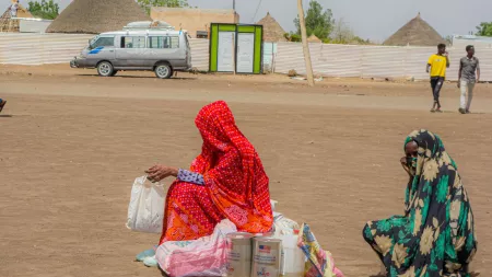 IDPs wait for transport after a food distribution at Un Gargor, Kassala, where thousands of displaced people from Sinnar and Sinjhah have settled following an escalation in violence.
