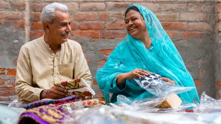 Woman and man sitting on the floor smiling at each other