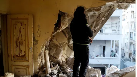 Man standing amid rubble