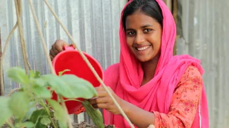 Jerin watering plants in her village in Bangladesh