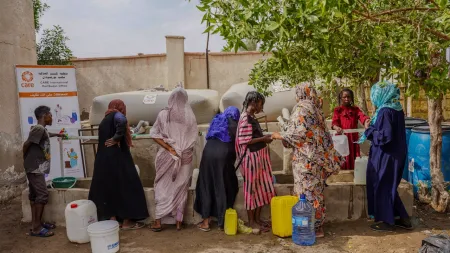 Residents sheltering at a school in Port Sudan access water and sanitation services