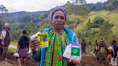 Women farmer receives seeds at a distribution event