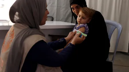 A child being screened for malnutrition at a CARE health facility in Deir Al-Balah.
