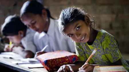 A girl in the UDAAN program smiles as she continues her education through accelerated learning for out-of-school girls.