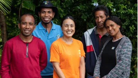 Yoko Ito, project manager, stands with participants in a rural livelihoods program focused on supporting livelihoods through agriculture and women's economic participation.