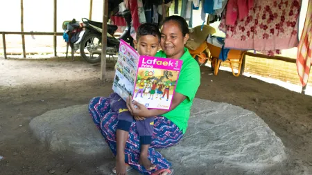 Adelina and her son, Denilson, read Lafeek magazine.