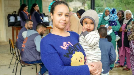 Ghofran and her daughter wait for aid at a shelter in Lebanon, where displaced families face growing humanitarian needs.