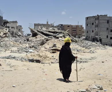 person walking amid rubble
